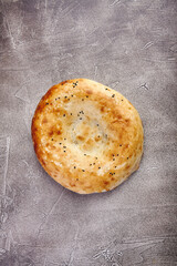 Delicious fresh tandir flatbread with black and white sesame seeds. National traditional Asian food