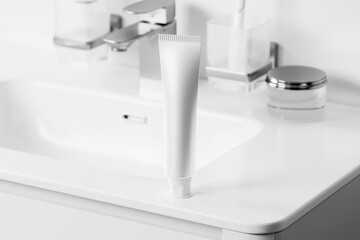 Toothpaste on white washbasin mockup. 3D rendering