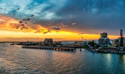 Cruise ship departing from Port Brisbane in Australia during thunderstorm in sunset sky - obrazy, fototapety, plakaty