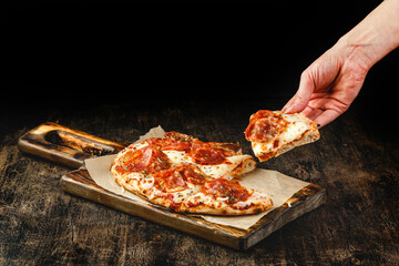 Roman-style pizza with jamon serrano. Roman square pizza or Pinsa on thick dough, Italian cuisine