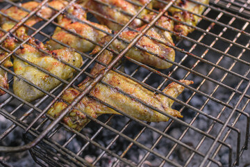Delicious chicken wings grilled on burning coals