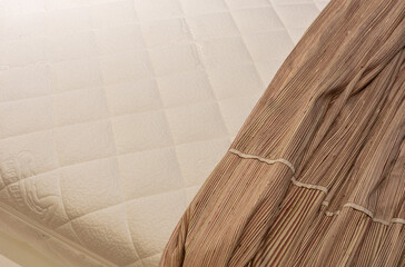 Fototapeta na wymiar Large latex mattress, latex mattress background in warm colors. Natural latex mattress with blurred background