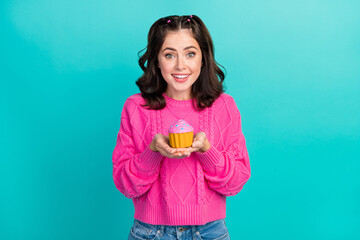 Photo of nice cute gorgeous girl wear pink pullover holding cupcake give you staring toothy beaming isolated on turquoise color background