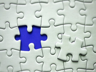 Jigsaw puzzle on blue background with customizable space for text or ideas. Copy space