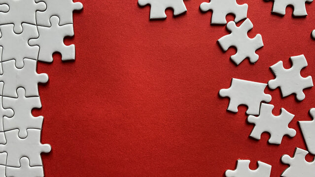 Jigsaw puzzle on red background with customizable space for text or ideas. Copy space