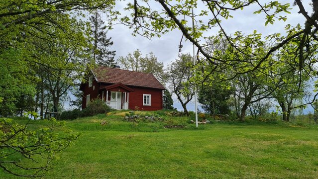 Beautiful wooden cottage surrounded by trees in Smaland, Sweden