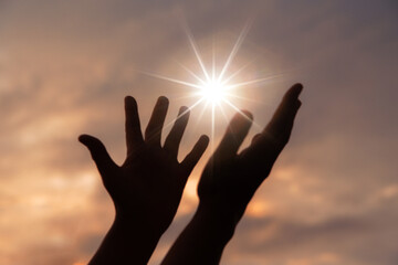 Person human hands open palm up worship or pray for god. background is sunrise. Concept for Christian, Christianity, Catholic religion, divine, heavenly, celestial or god. - obrazy, fototapety, plakaty