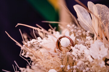 a pair of rings on top of a bouquet of flowers