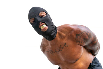 Shirtless tattooed African American man leaning in with black mask and gold fangs