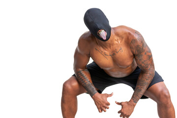 Shirtless tattooed African American man with eyeless black mask, gold fangs, and tongue sticking out