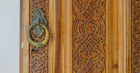 Vintage arabian wooden door close up shot. Beautiful antique hand craft texture