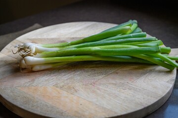Green onions on wooden board