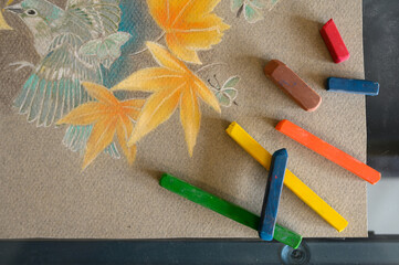 Bunch of pastels on drawing