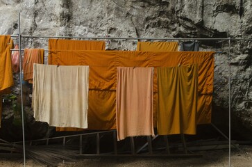 orange religious monk robes drying on the clothesline in Thailand