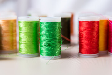 green and red, close-ups of colored threads, dressmaker, atelier, seamstress, sewing clothes,...