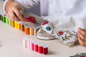 colored thread, embroidered garment, dressmaker, atelier, sewing, sewing clothes, embroidering a fabric, selective focus