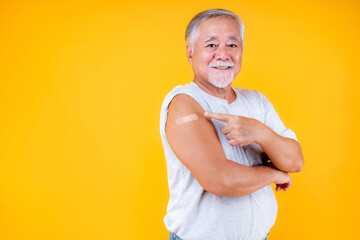 old man potint arm with plaster fully vaccinated or booster vaccinated able to travel to various countries , elderly man fully vaccinated or booster vaccinated.