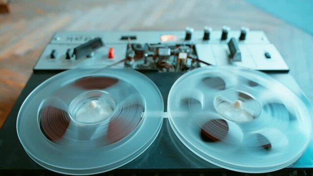 Fast forwarding a tape on an old reel to reel tape recorder.