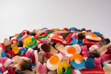 Tasty mix of jelly colorful candies isolated on a white background.