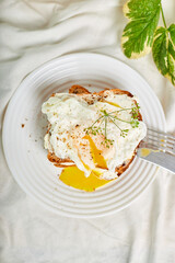 Breakfast on white bed sheets, good morning, toast with poached eggs, coffee, flowers, Hotel room early morning, honeymoon