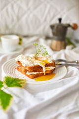 Breakfast on white bed sheets, good morning, toast with poached eggs, coffee, flowers, Hotel room early morning, honeymoon