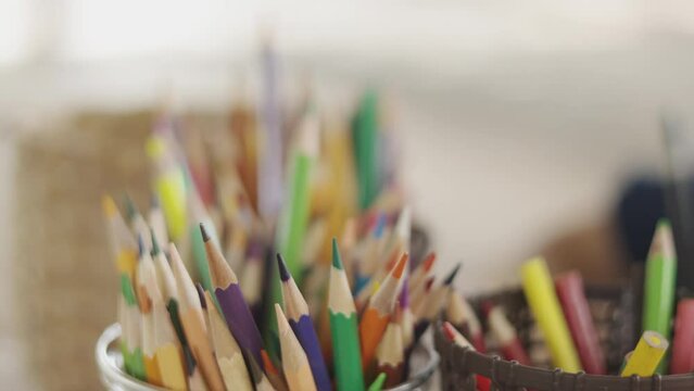 Selective focus 4K of many and colorful multi-color pencils on table with copy space of kid who is drawing and painting. It shows concept of development for creativity and imagination of child.