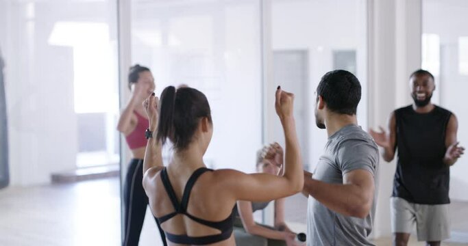 Motivation, fun and support in fitness class or center by friends cheering during physical challenge. Excited, fun group exercising together, celebrating body goals, and benefits of healthy lifestyle