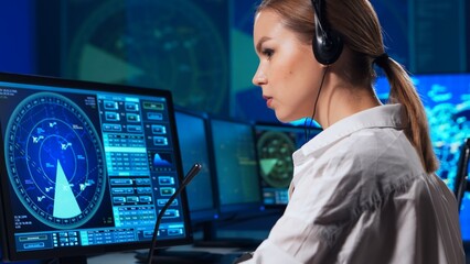 Workplace of the air traffic controllers in the control tower. Team of professional aircraft control officers works using radar, computer navigation and digital maps. Aviation concept.