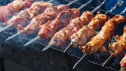 The meat is cooked on the grill. The process of cooking barbecue on coals.