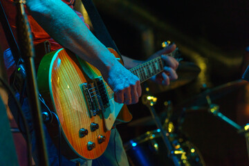 The guitarist plays on guitar. Hands of a Guitar player playing the guitar. Selective focus. Soft focus
