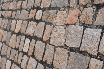 Stone wall texture background. Stone arrangement in pattern. Abandoned stone wall construction in the historical heritage site at shore temple complex at Mahabalipuram, Tamilnadu, India.