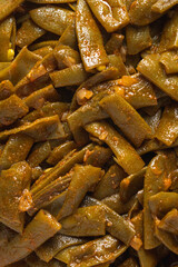 Green beans with olive oil on a white porcelain plate. Healthy eating concept