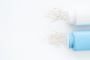 Spilled white talcum powder in container. Skin care cosmetic