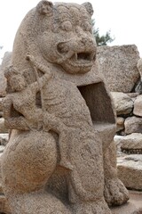 Monolithic stone carved lion sculpture in the complex of Shore temple at Mahabalipuram, Tamilnadu, India. Historical animal sculpture carvings in the heritage sites at India.