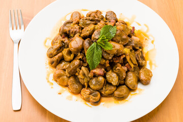 Green beans with ham on a plate, typical Spanish food.