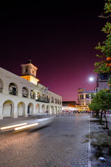 Fototapeta na wymiar Historic center of the city of Salta in Argentina at sunset with the town hall with light trails from cars in front vertical view