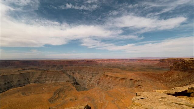Time lapse tracking shot of incoming clouds over deserted canyons in Southern Utah, USA