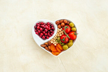 Healthy lifestyle and nutrition eating concept with food in heart shaped dish