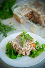 jellied meat with greens and vegetables in a plate