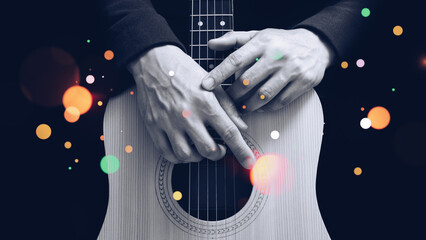 black and white male guitarist hands on acoustic guitar body with colorful bokeh, isolated on...