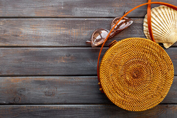 Woman's beach accessories - rattan bag with sunglasses and seashells