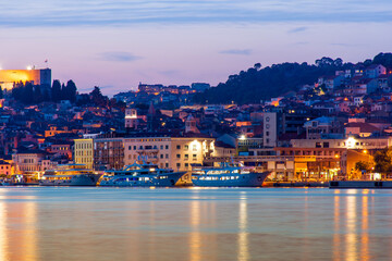 Evening Sibenik city in Croatia, night city lights reflection, cityscape