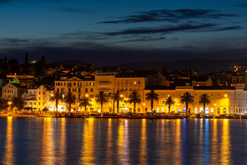 Fototapeta na wymiar Evening city of Split in Croatia, reflection of the lights of the night city.