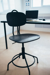 Empty work space chair, desk with laptop