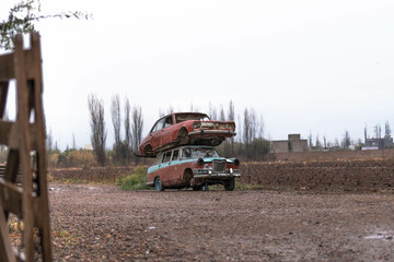 piled up scrap of cars in field