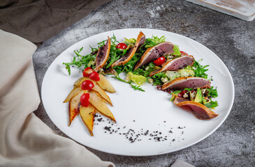 Salad with tuna, avocado, arugula greens, candied pear and cherry tomatoes