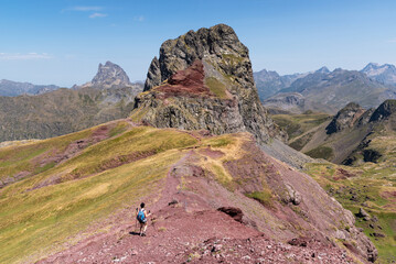 Woman hiker towards Anayet Peak. Midi d'Ossau in the background