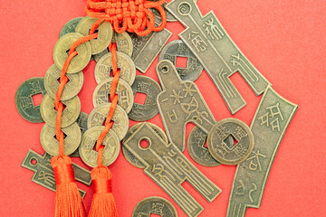 Background asian ritual Feng Shui coins with red knot good luck. Translation: Coins during the...