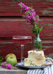 Still life with French cheese. Soft cheese close up photo. French appetizer on a plate. 