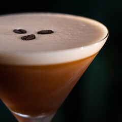 espresso martini cocktail with foam and three coffee beans